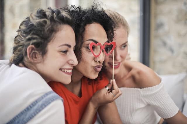 three female friends posing for a pic