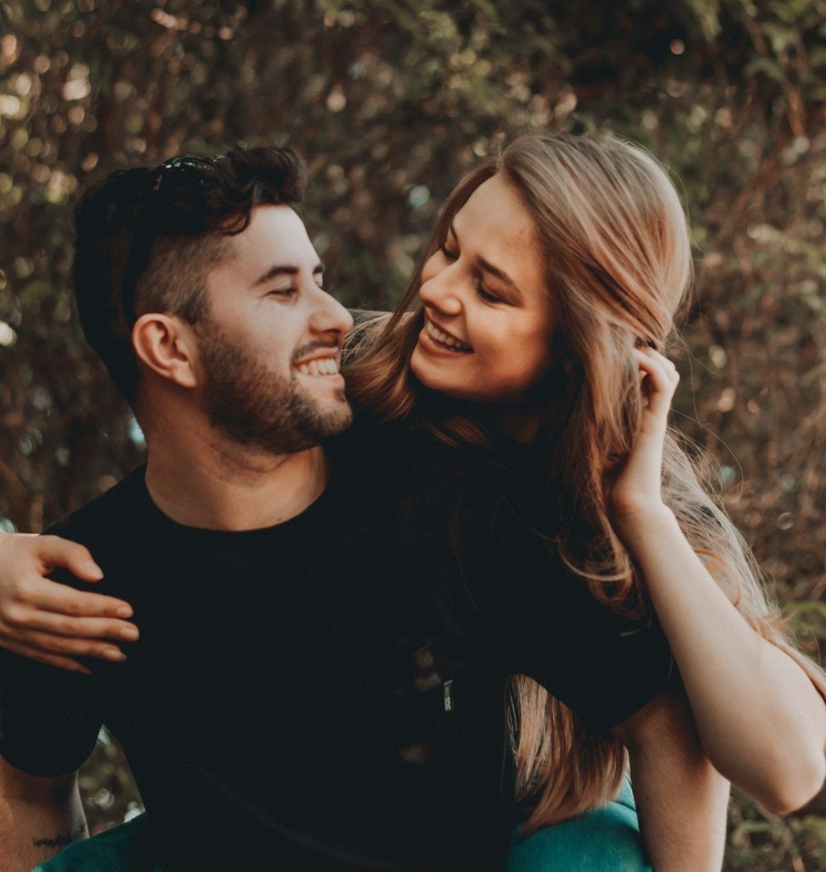 a happy male and female couple smiling at themselves