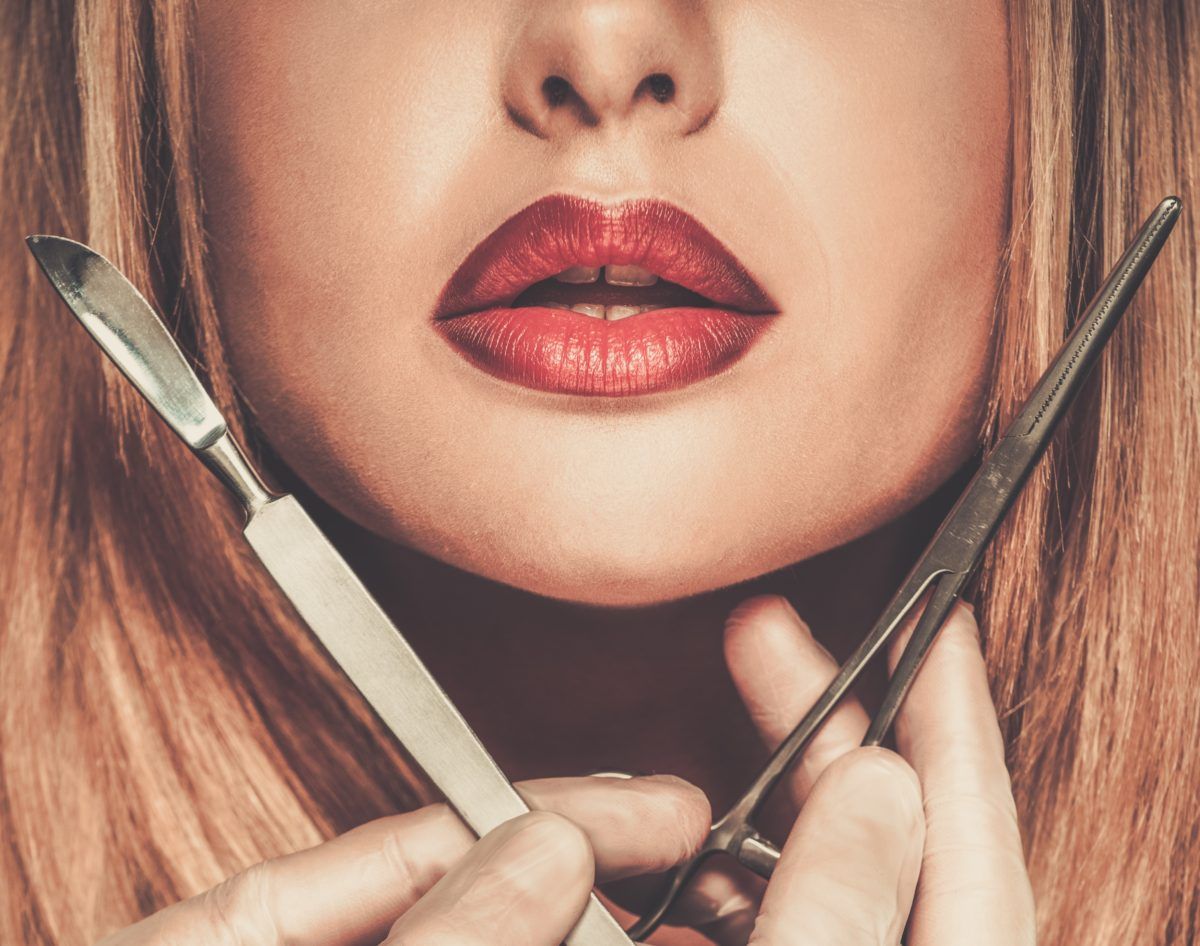 Hands with plastic surgery tools near young woman face