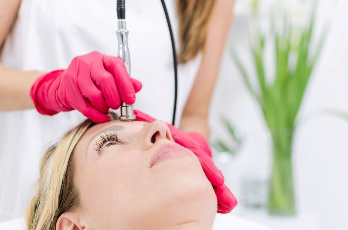 woman receiving microneedling treatment