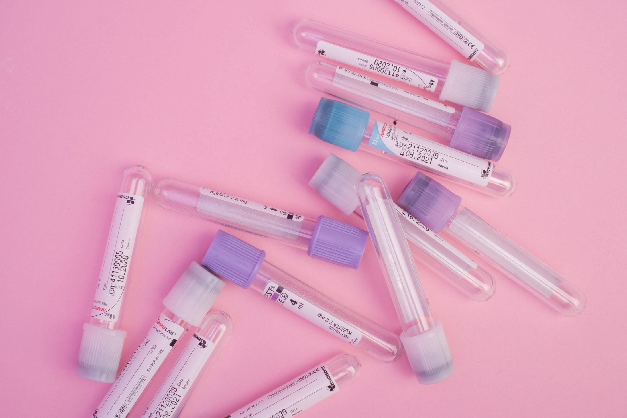 containers of serums against pink background