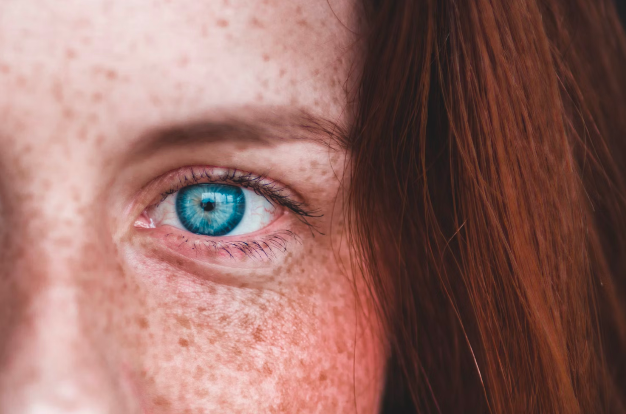 close up of woman with blue eyes and freckles