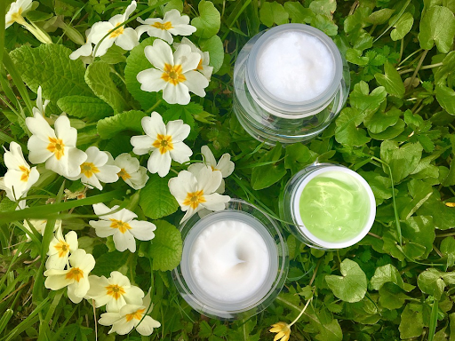 skin care cream with a background of grass and flowers